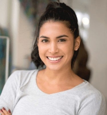 Happy patient with aligned teeth after getting Orthodontic Metal Braces in Albany